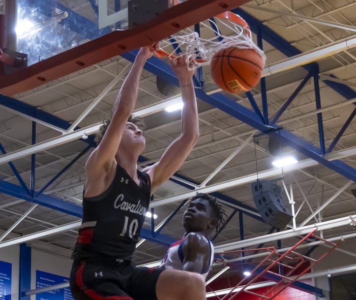 Hudson Greer, Lake Travis four-star, slam dunks around Austin Westlake center Wonder Kahozi looks on during the second quarter at a 6A District 26 game in December.